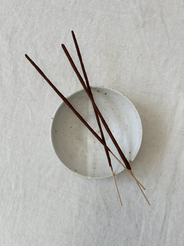 3 premium incense sticks resting on a handmade ceramic dish